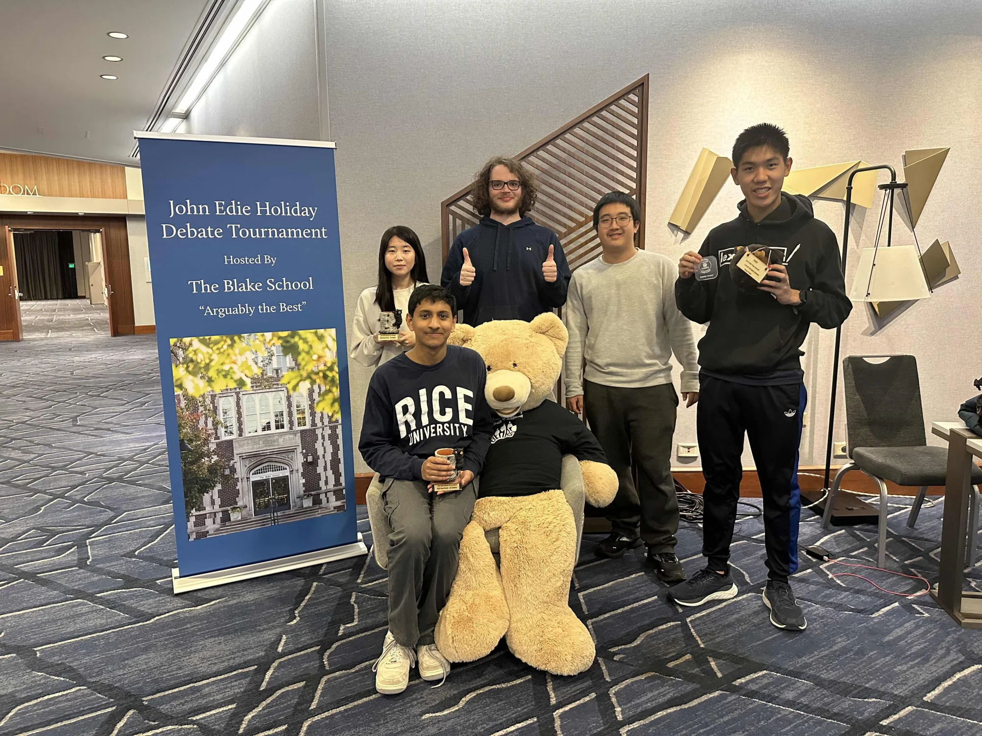 Break students at the John Edie Holiday Debate Tournament with elimination round trophies