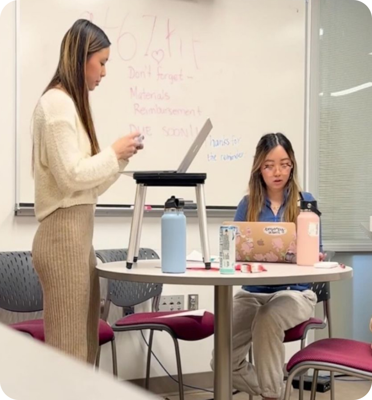 Two Break students mid drill, one delivering a speech with a laptop on a stand while the other flows the round